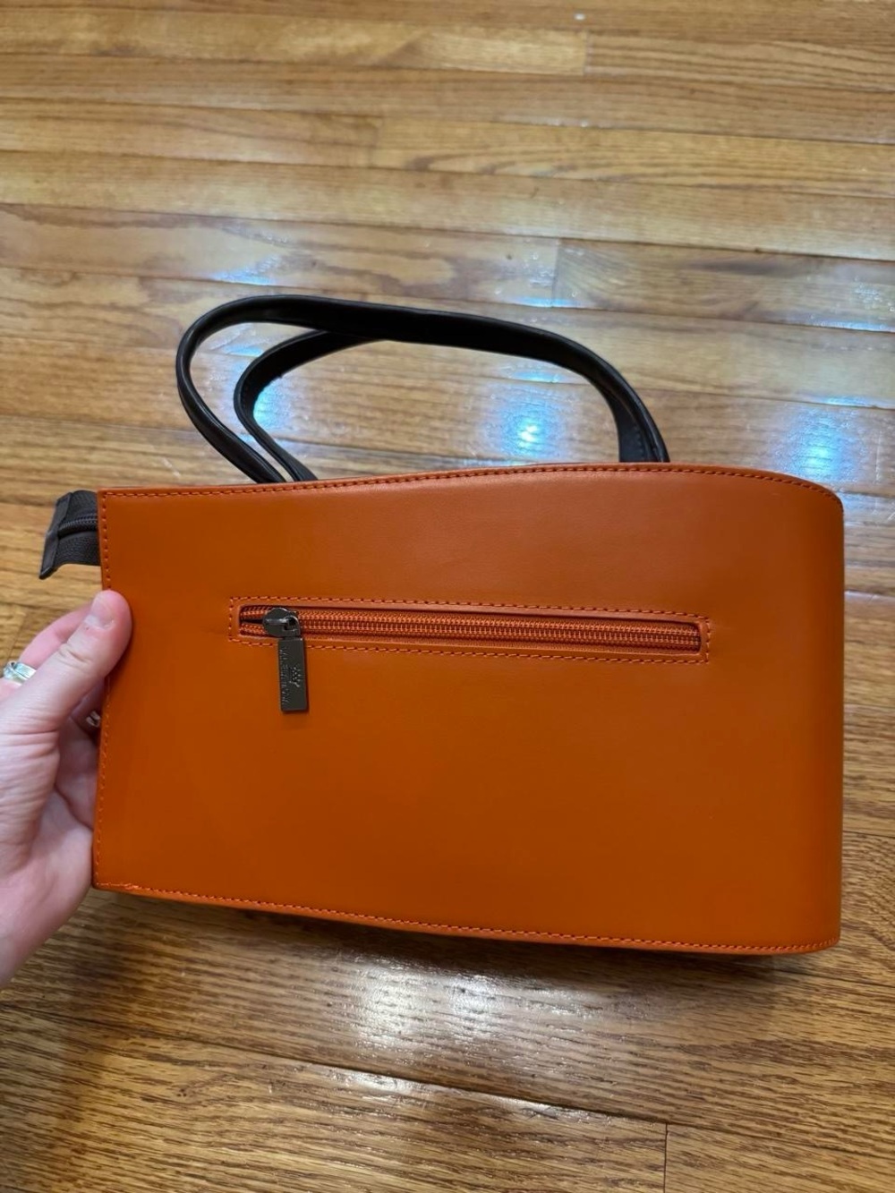 orange daniela voda handbag with black handles